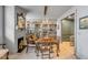 Inviting dining room featuring a fireplace, built-in shelving, and an adjacent prep kitchen area at 70 King St, Charleston, SC 29401