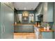 A sophisticated kitchen boasts wooden countertops and custom-painted cabinetry at 70 King St, Charleston, SC 29401