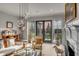 Sunlit living room featuring hardwood floors, modern lighting, and a view to the manicured backyard at 70 King St, Charleston, SC 29401