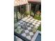 Charming outdoor patio with checkerboard tile, brick accents, and stylish seating, perfect for relaxing at 70 King St, Charleston, SC 29401