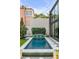 Inviting backyard pool with tiled accents, decorative elements, and an adjacent modern glass-walled structure at 70 King St, Charleston, SC 29401