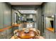 Stylish prep kitchen with green cabinetry, wood countertops, and view into the main kitchen area at 70 King St, Charleston, SC 29401