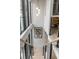 Modern staircase with cable railing, hardwood steps, and large windows providing ample natural light at 70 King St, Charleston, SC 29401