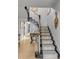 Inviting staircase featuring patterned carpet runner, decorative newel posts, and elegant wall decor at 70 King St, Charleston, SC 29401