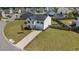 Aerial view of a pristine home featuring a well-manicured lawn and a convenient two-car garage at 715 Mcroy St, Moncks Corner, SC 29461