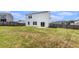 Large, fenced backyard with a two story home and a small patio at 715 Mcroy St, Moncks Corner, SC 29461