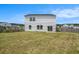Large fenced in backyard with a two story white home and sliding glass doors at 715 Mcroy St, Moncks Corner, SC 29461