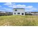 Fenced backyard with a view of the back of the white home, and manicured lawn at 715 Mcroy St, Moncks Corner, SC 29461