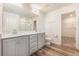 Bright bathroom featuring a double sink vanity, wood-look flooring and separate toilet room at 715 Mcroy St, Moncks Corner, SC 29461