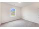 Cozy bedroom with soft carpet flooring and a bright window overlooking the backyard at 715 Mcroy St, Moncks Corner, SC 29461