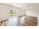 Bright dining area with wood flooring, a modern chandelier, and sliding glass doors to the backyard at 715 Mcroy St, Moncks Corner, SC 29461