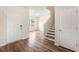 Bright entryway featuring hardwood floors, a staircase, and a view into the living area at 715 Mcroy St, Moncks Corner, SC 29461