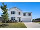 Charming two-story home with white siding, a two-car garage, and a well-manicured front lawn at 715 Mcroy St, Moncks Corner, SC 29461