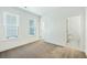 Bright bedroom with two windows and neutral carpet, adjacent to an ensuite bathroom and closet at 816 Gentle Breeze Dr, Summerville, SC 29486