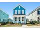 Charming two-story home with blue siding, a white front porch, and manicured landscaping in a neighborhood setting at 816 Gentle Breeze Dr, Summerville, SC 29486