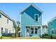 View of back of a home with attractive blue siding, a well-kept lawn, and neighboring houses at 816 Gentle Breeze Dr, Summerville, SC 29486