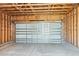 Spacious, unfinished garage with an open ceiling and automatic door at 816 Gentle Breeze Dr, Summerville, SC 29486