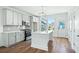 Stylish kitchen boasting white cabinets, stainless steel appliances, an island, and hardwood floors at 816 Gentle Breeze Dr, Summerville, SC 29486