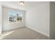 Bedroom with neutral carpeting, baseboards and a large window with a view at 827 Alma Square Dr, Moncks Corner, SC 29461