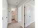 Upstairs hallway with neutral carpet and an open doorway leading into a bathroom with a vanity at 827 Alma Square Dr, Moncks Corner, SC 29461