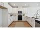 Well-lit kitchen with white cabinetry, stainless steel appliances, and marble countertops at 827 Alma Square Dr, Moncks Corner, SC 29461