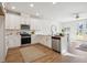 Modern kitchen boasting white cabinetry, stainless steel appliances, quartz countertops, and a seamless open-concept design at 827 Alma Square Dr, Moncks Corner, SC 29461