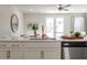 Kitchen area featuring marble countertops, white cabinetry, and stainless steel dishwasher at 827 Alma Square Dr, Moncks Corner, SC 29461
