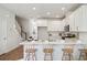 Bright kitchen with an island, white cabinetry, marble countertops, and wooden barstools at 827 Alma Square Dr, Moncks Corner, SC 29461
