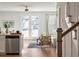 Bright living space showcasing hardwood floors, stylish furniture, and natural light streaming through the back doors and window at 827 Alma Square Dr, Moncks Corner, SC 29461