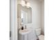 Clean powder room featuring a pedestal sink, modern mirror, and a sleek white toilet at 827 Alma Square Dr, Moncks Corner, SC 29461