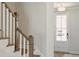 Staircase with white railing, hardwood steps, and a glass-paneled front door at 827 Alma Square Dr, Moncks Corner, SC 29461