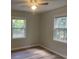 Comfortable bedroom featuring wood-look floors and dual windows for ample light at 8392 Herbert Smalls Rd, Edisto Island, SC 29438