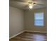 Cozy bedroom with wood-look flooring and natural light from the window at 8392 Herbert Smalls Rd, Edisto Island, SC 29438