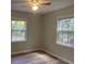Comfortable bedroom featuring wood-look floors and dual windows for ample light at 8392 Herbert Smalls Rd, Edisto Island, SC 29438