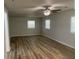 Spacious bedroom features multiple windows and wood flooring at 8392 Herbert Smalls Rd, Edisto Island, SC 29438