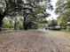 The two-story home features a sprawling yard with mature trees at 8392 Herbert Smalls Rd, Edisto Island, SC 29438