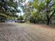 Spacious front yard with mature trees and lush landscaping surrounding a charming brick home at 8392 Herbert Smalls Rd, Edisto Island, SC 29438