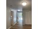 Open hallway with bright lights and wood flooring at 8392 Herbert Smalls Rd, Edisto Island, SC 29438