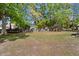 Expansive backyard offering ample space for recreation and relaxation, surrounded by mature trees and greenery at 8524 Belford Ct, North Charleston, SC 29420