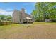 Expansive backyard with lush lawn, mature trees, and a charming pergola-covered patio, ideal for outdoor living at 8524 Belford Ct, North Charleston, SC 29420