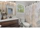 Bathroom featuring a modern vanity, toilet, and a shower-tub combo with stylish curtain at 8524 Belford Ct, North Charleston, SC 29420