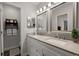 Bright bathroom features a double sink vanity and decorative shelving, creating a serene and functional space at 8524 Belford Ct, North Charleston, SC 29420
