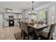 Dining area with dark table and six chairs next to bright and spacious kitchen at 8524 Belford Ct, North Charleston, SC 29420