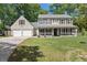 Charming two-story home featuring a welcoming front porch and a two-car garage at 8524 Belford Ct, North Charleston, SC 29420