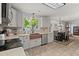 Open-concept kitchen featuring stainless appliances, granite counters, copper sink, and dining area at 8524 Belford Ct, North Charleston, SC 29420