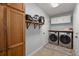 Efficient laundry room featuring modern appliances, storage cabinets, and a convenient shelf at 8524 Belford Ct, North Charleston, SC 29420
