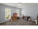 Spacious playroom with large windows, play kitchen, dollhouse, and plenty of space to play at 8524 Belford Ct, North Charleston, SC 29420