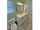 Bright bathroom with tiled floors, toilet, vanity, and a framed rectangular mirror above sink at 855 Hunt Club Run, Charleston, SC 29414