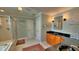 Bright bathroom featuring double sinks, black countertops, and tiled floors at 855 Hunt Club Run, Charleston, SC 29414