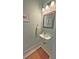 Small bathroom featuring a wall-mounted sink, mirror, and tiled floors at 855 Hunt Club Run, Charleston, SC 29414